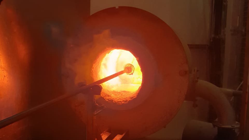 The colored shards are melted into the glass with a reheating chamber  (known as the glory hole). Photo: Archive of the Czech Center New York