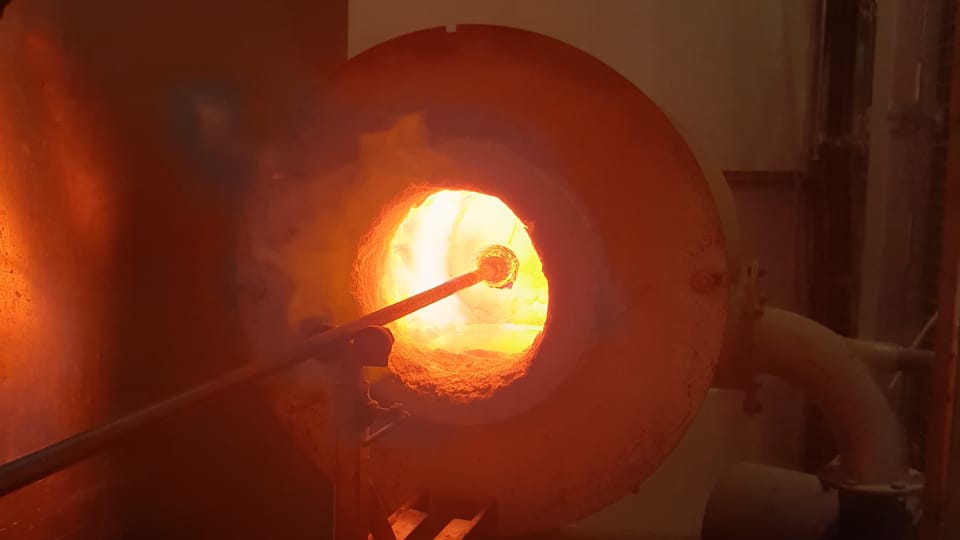 The colored shards are melted into the glass with a reheating chamber (known as the glory hole). Photo: Archive of the Czech Center New York The colored shards are melted into the glass with a reheating chamber (known as the glory hole). Photo: Archive of the Czech Center New York