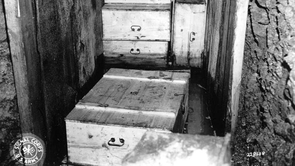 An inside view of the cave shows the manner in which the boxes were packed. Cans of dynamite were planted between the crates as booby traps. (111-SC-228308), photo: US National Archives An inside view of the cave shows the manner in which the boxes were packed. Cans of dynamite were planted between the crates as booby traps. (111-SC-228308), photo: US National Archives