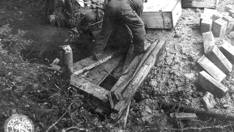 To pull the boxes up the steep ravine,  the team tied rope around each box and pulled it up about 100 yards by winch.  (111-SC-228305),  photo: US National Archives